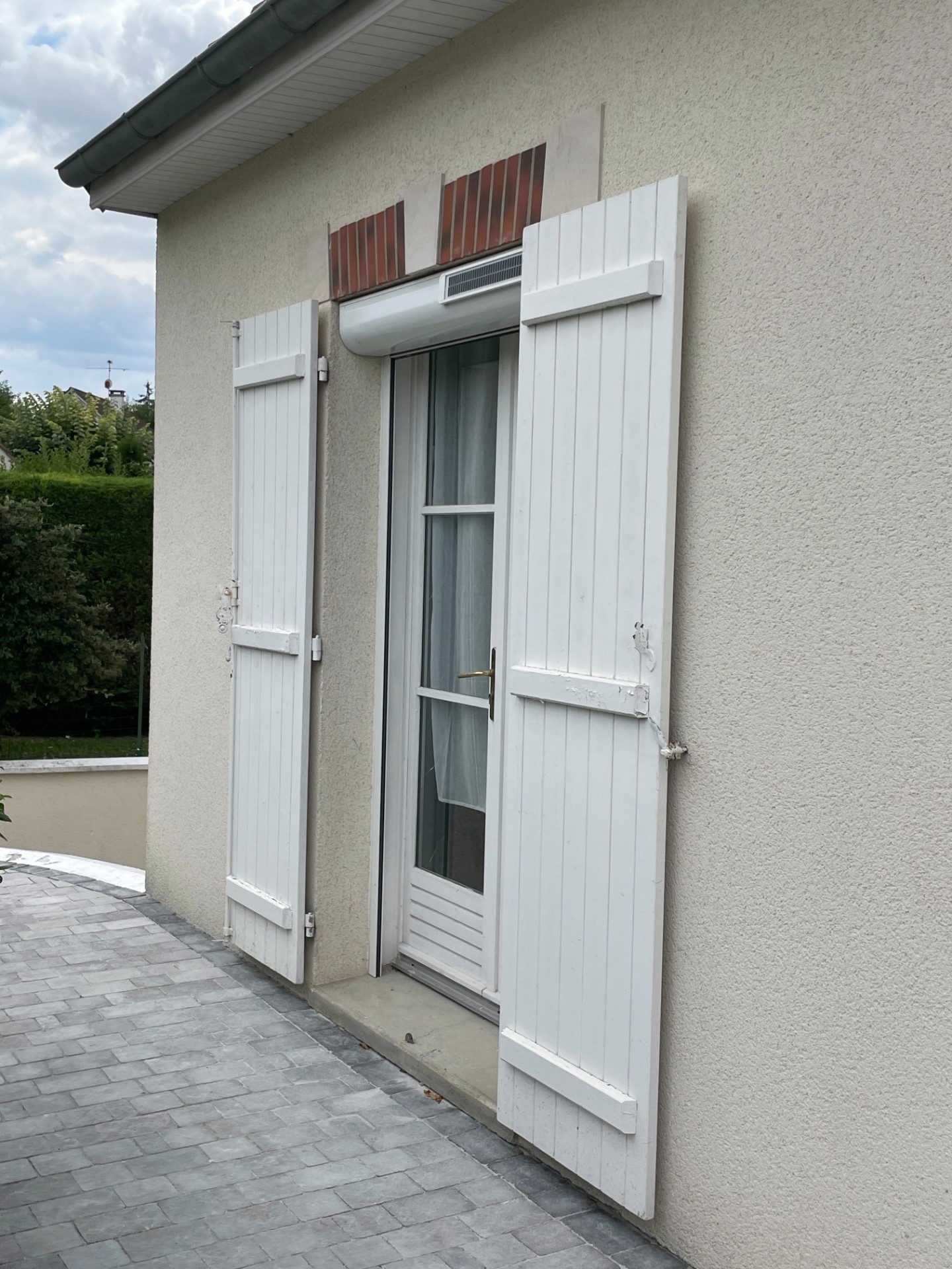 Volet roulant solaire avec battants blancs